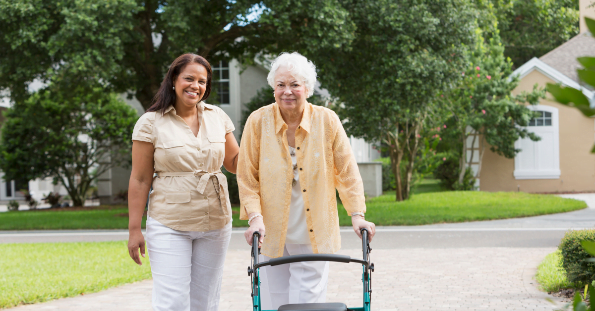 caregiver walking with elderly