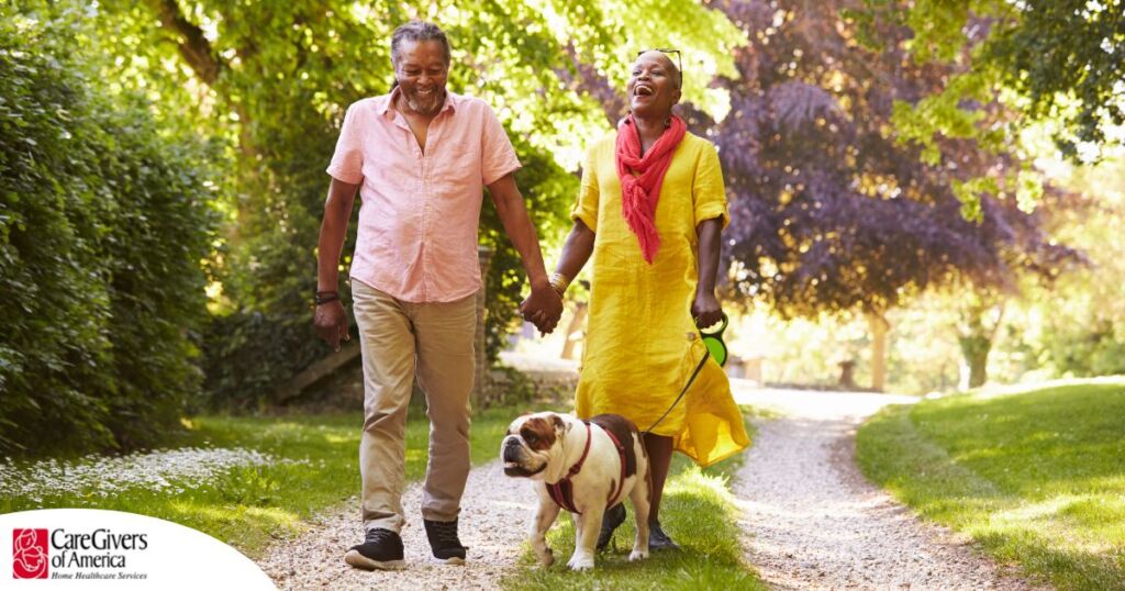 Walks, like this older couple and their dog are engaged in, are great activities for seniors in the springtime.