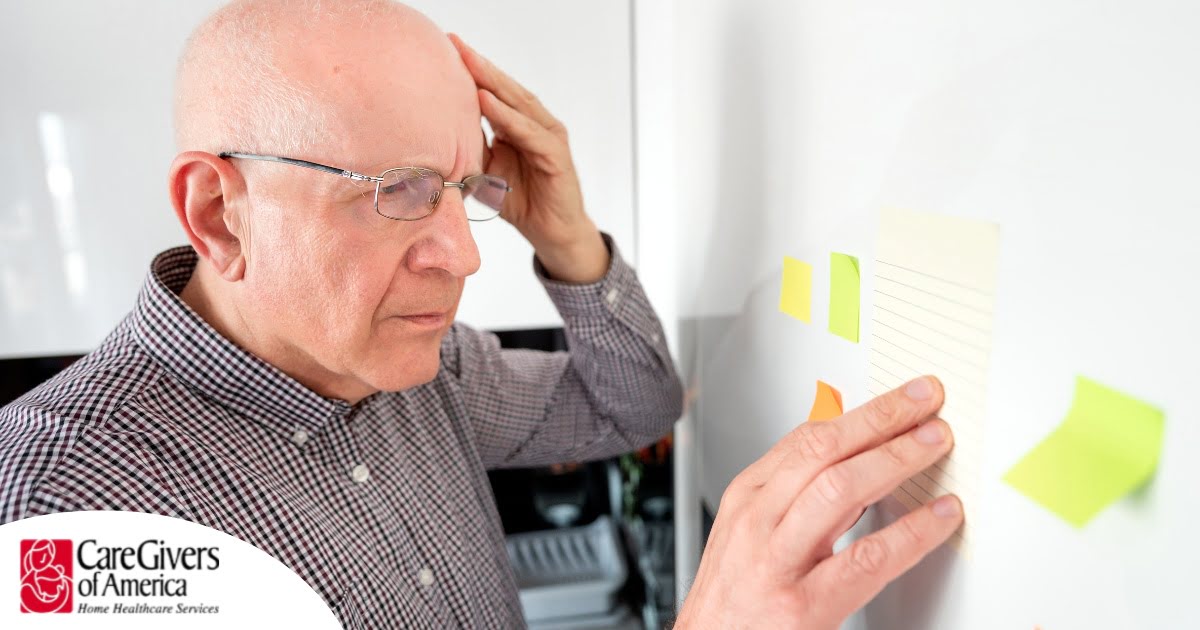 A senior looks at a board confused, representing one of the potential signs of dementia.