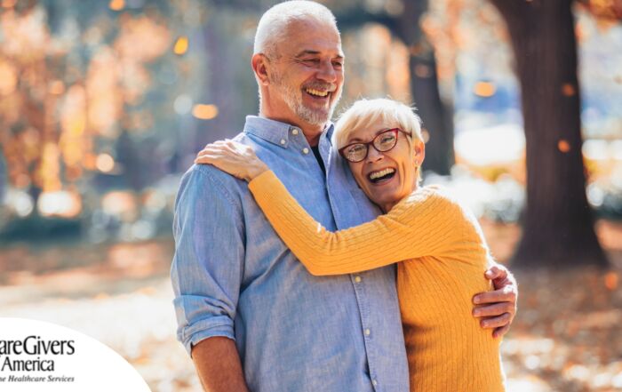 An older couple enjoys being outside in the fall, representing the idea of different fall activities for seniors.