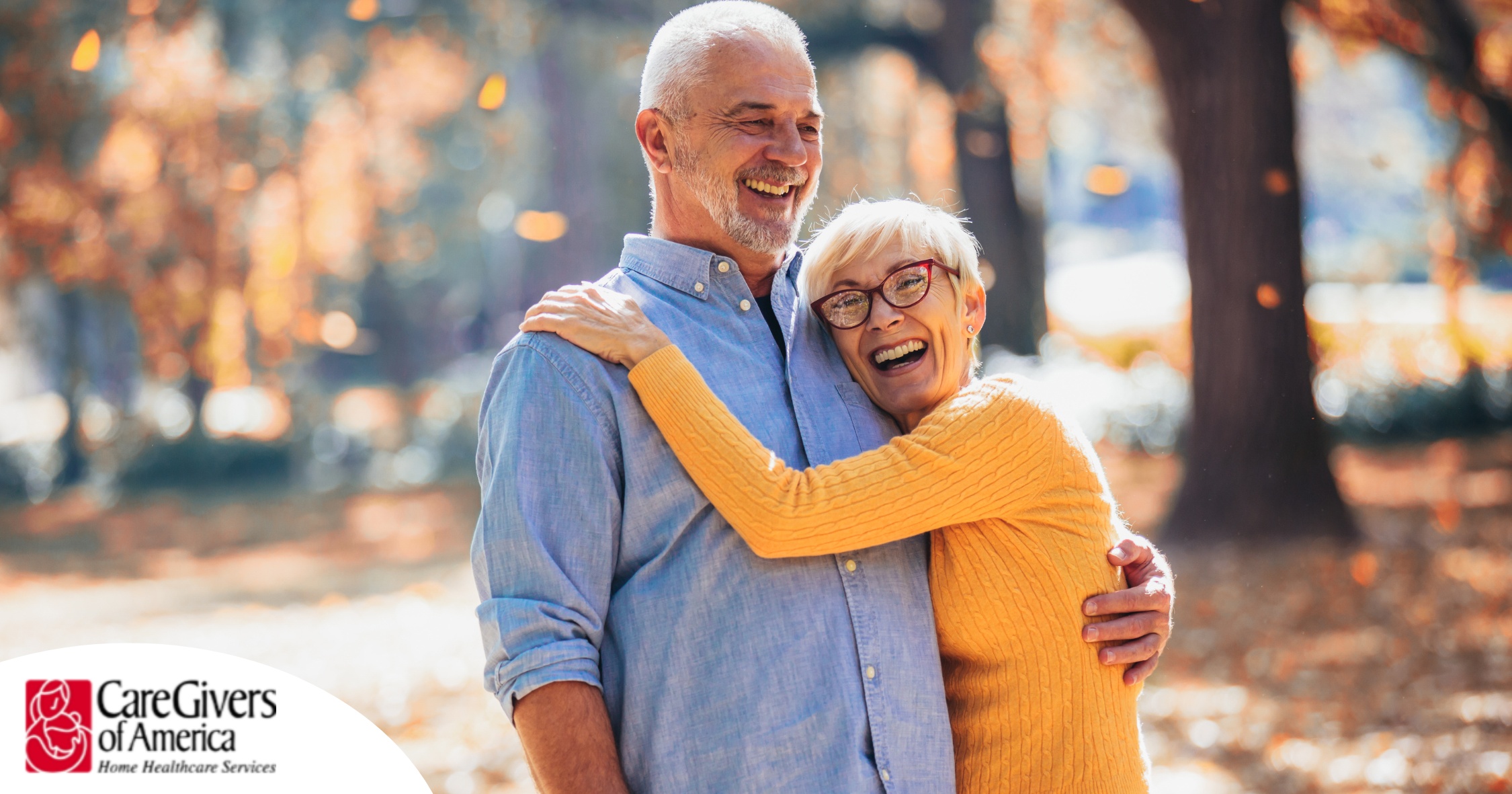 An older couple enjoys being outside in the fall, representing the idea of different fall activities for seniors.