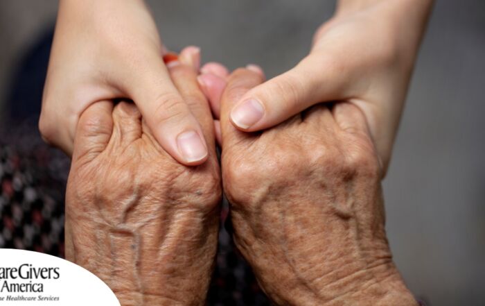 Younger hands hold older ones, representing the care and compassion of caregiving and how caregivers can help, even in ways like implementing stroke prevention strategies.