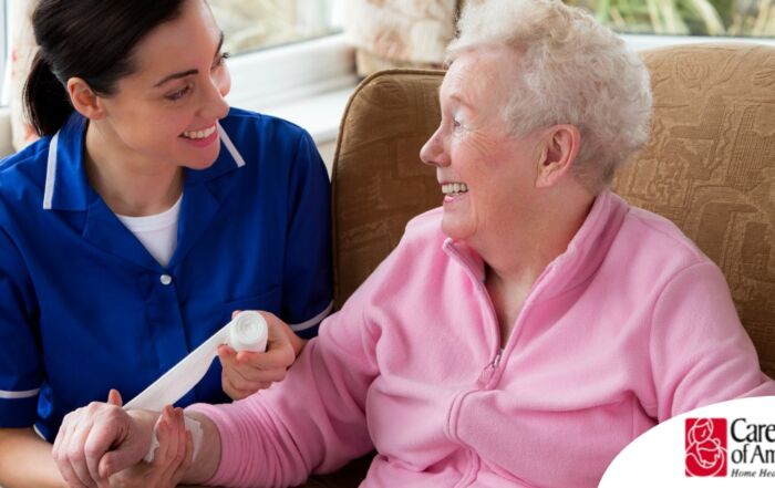 A caregiver demonstrates wound care by wrapping a senior client’s wound.