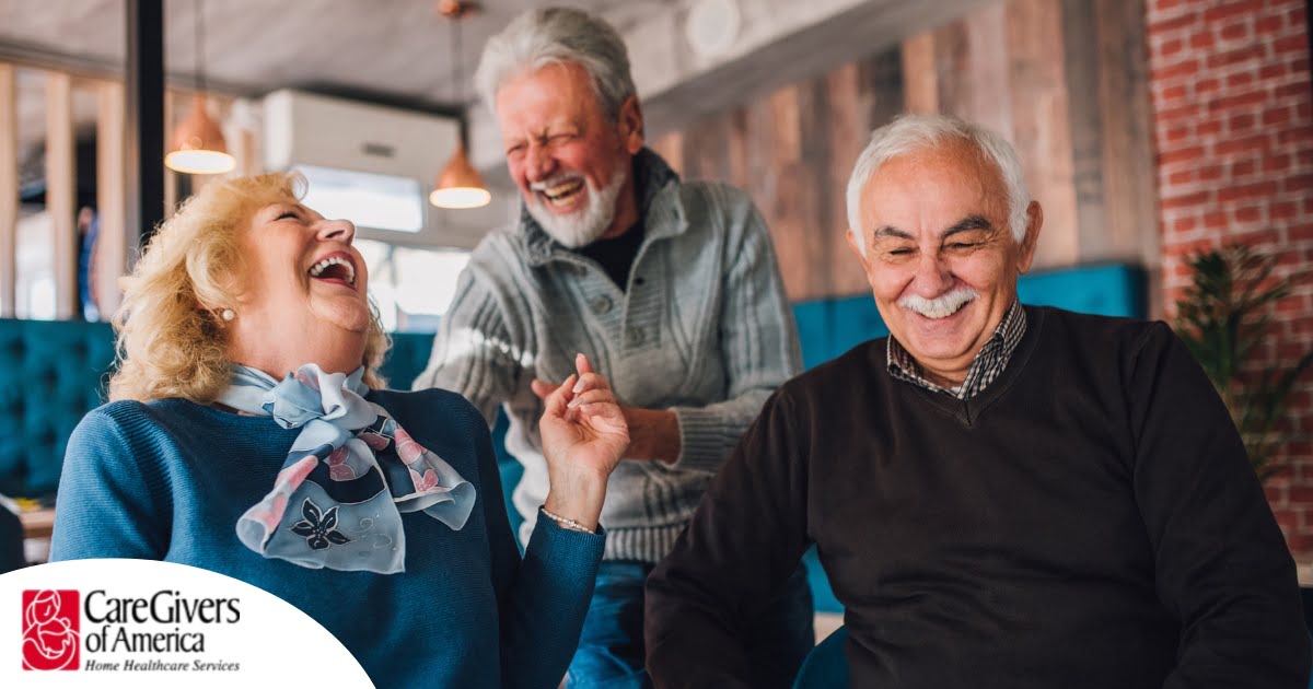 Older adults laugh and enjoy each other’s company representing how socialization can help seniors.