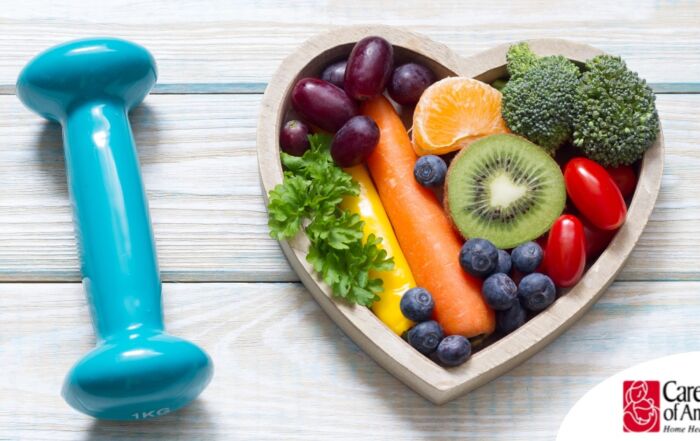 A heart with nutritious food and a dumbbell represents the healthy lifestyle that National Cholesterol Education Month promotes.