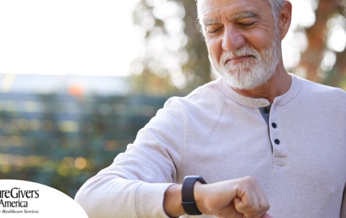 A senior man wears a smart watch, representing one of the many ways smart technology is shaping home health care.