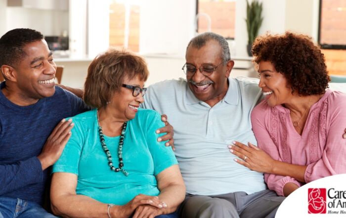 A couple sits with aging parents and enjoys their time together.