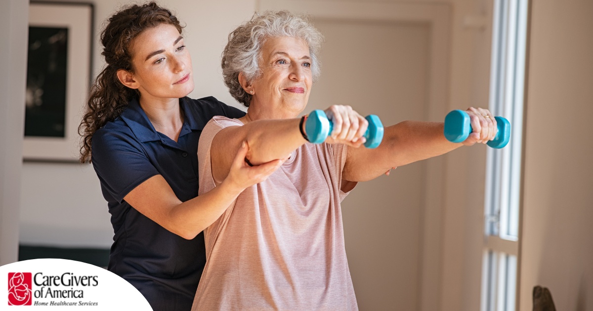 A physical therapist helps an older patient lift weights, representing how home health professionals can help with the hospital to home transition and the recovery that it entails.