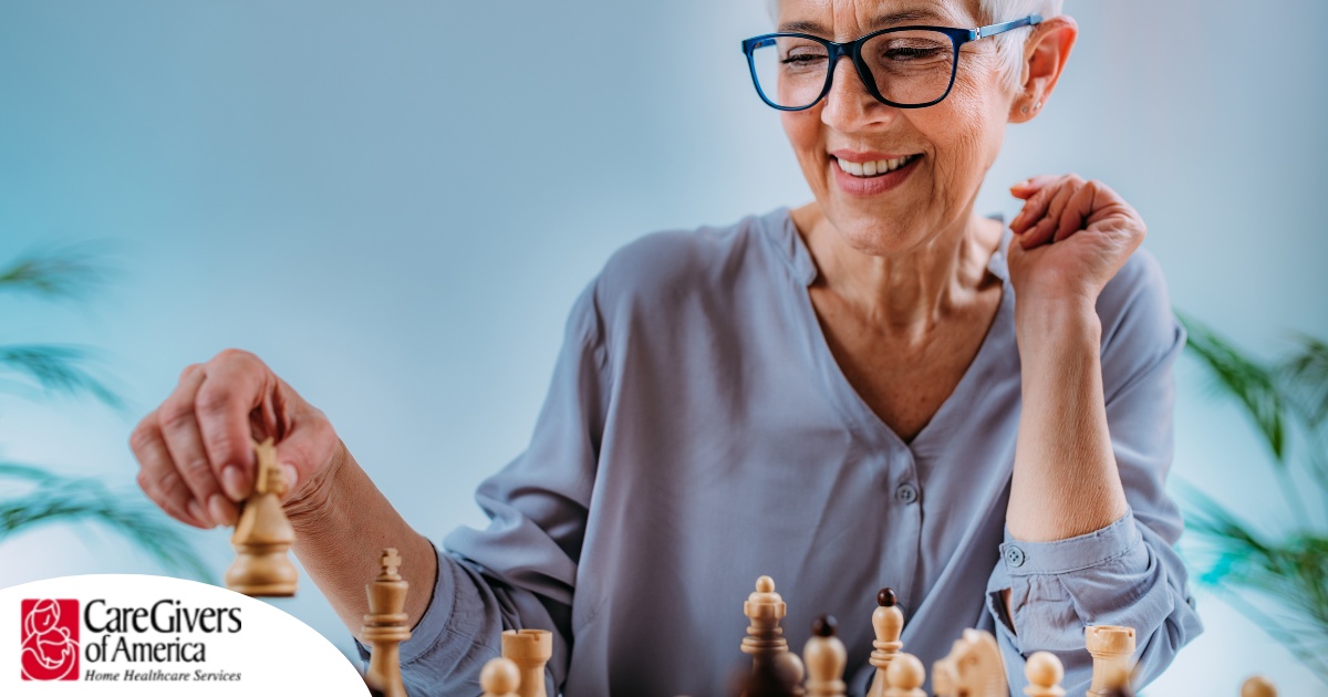 An older woman plays chess, an activity that can help older adults stay sharp.