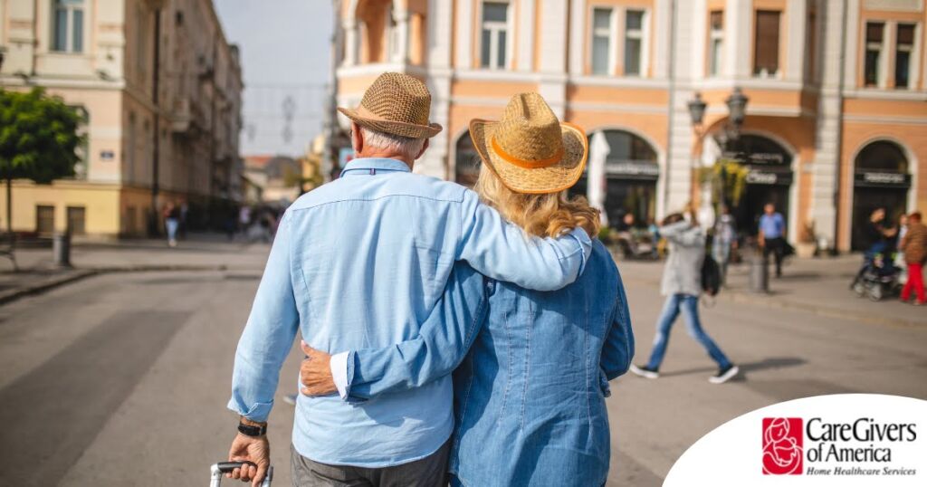 2 older adults hug while on vacation representing the successful outing that can still happen while caring for elderly loved ones.