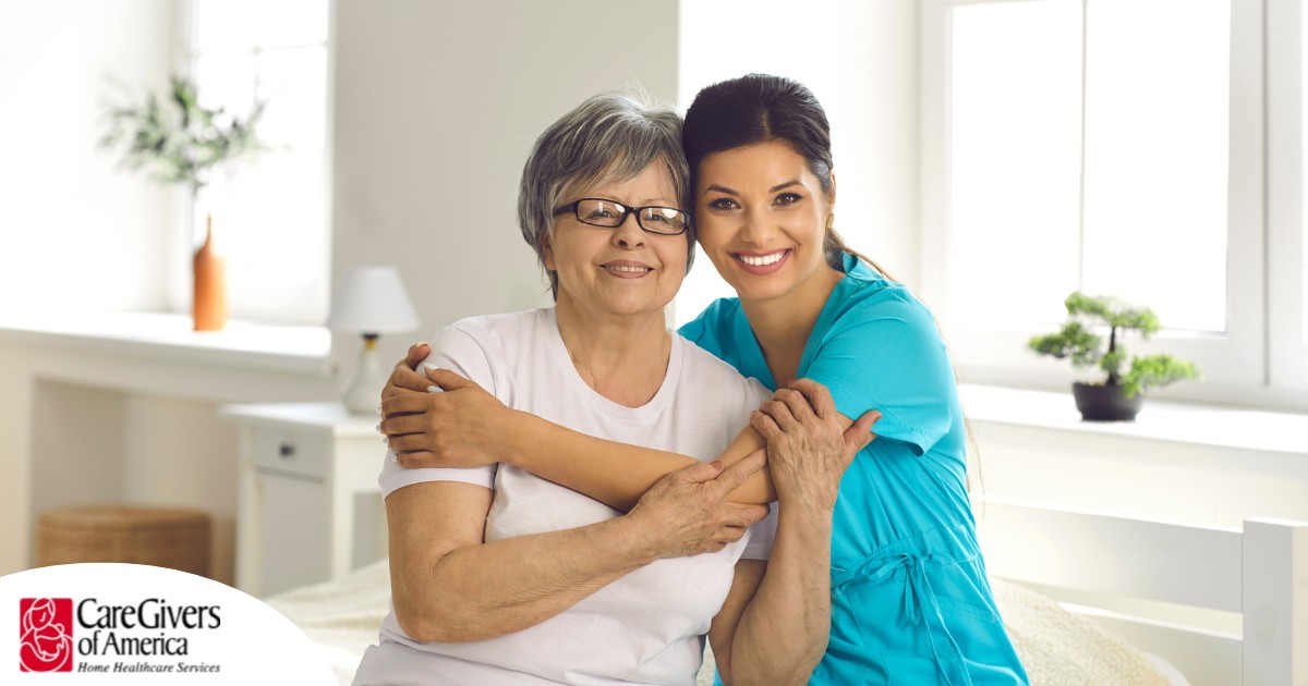 A caregiver hugs an older client, representing how a trustworthy caregiver cares for clients.