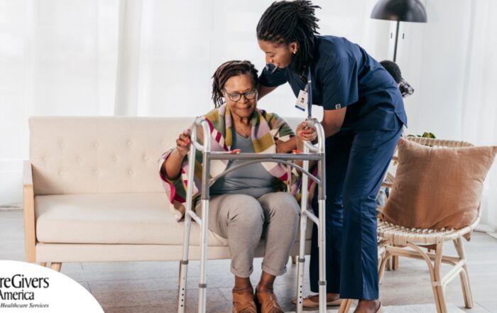 A care professional helps an older woman get up with the use of a walker, representing how occupational therapy can help with recovery.