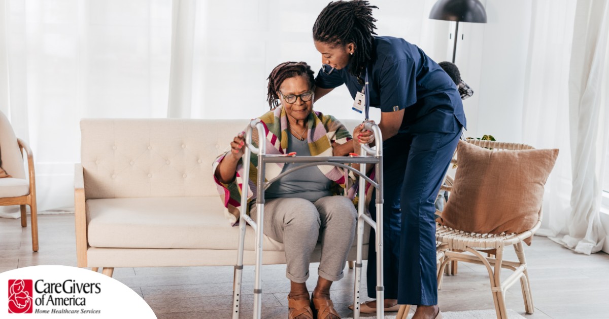 A care professional helps an older woman get up with the use of a walker, representing how occupational therapy can help with recovery.