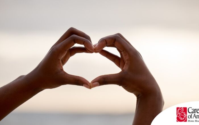 2 hands making a heart represent self-care, a vital concept to appreciate as a caregiver.
