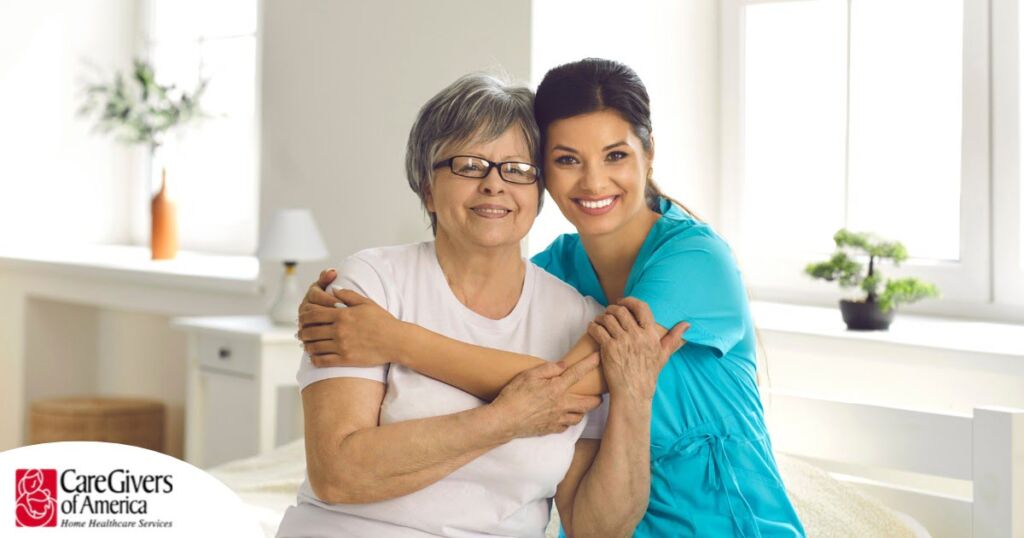 A caregiver hugs an older client, representing how a trustworthy caregiver cares for clients.
