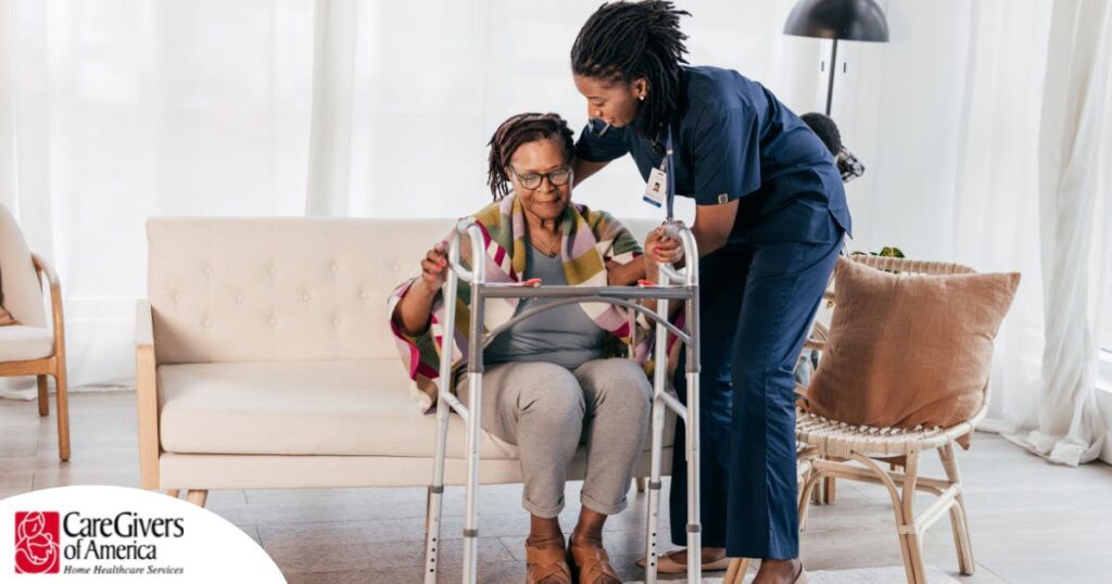 A care professional helps an older woman get up with the use of a walker, representing how occupational therapy can help with recovery.