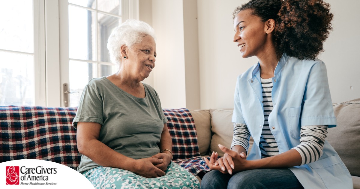 A caregiver sits and spends time with a client, representing how non-medical home care can benefit older loved ones.