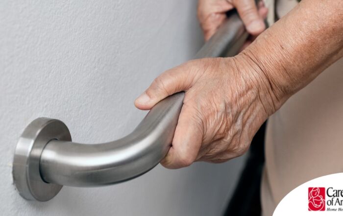 An older adult uses a grab bar representing one of the home modifications that is helpful for fall prevention for elderly adults.