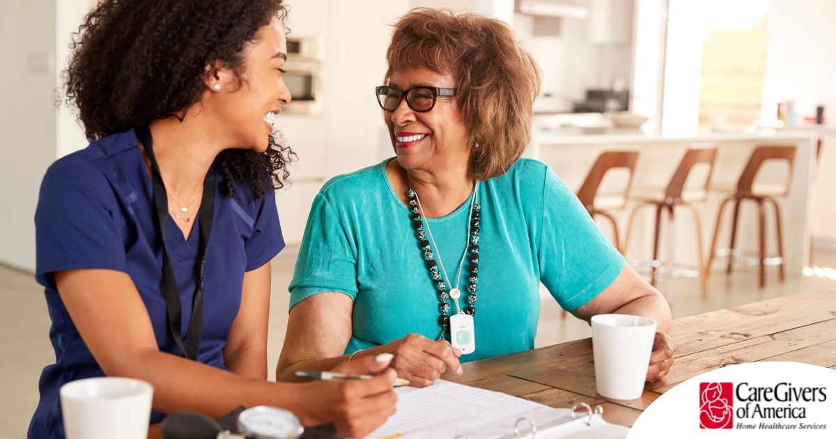 A care provider smiles with an older patient, representing the good results of speech therapy.