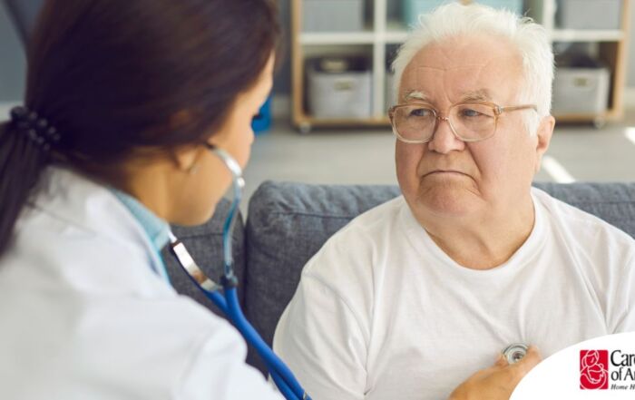 A doctor examines an older man with a stethoscope, representing pneumonia in elderly adults.