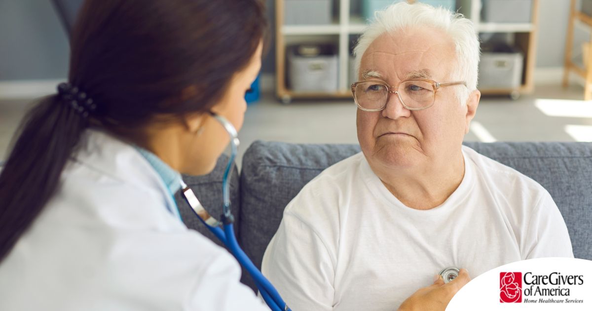 A doctor examines an older man with a stethoscope, representing pneumonia in elderly adults.