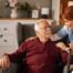 A caregiver helping a woman with a walker make her senior home safer.