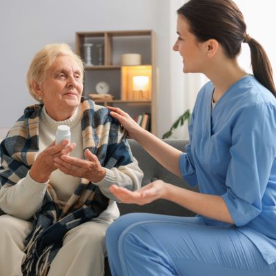 Caregiver discussing medication with an elderly woman at home in Palm Beach Gardens while providing Medication Supervision in Palm Beach Gardens.