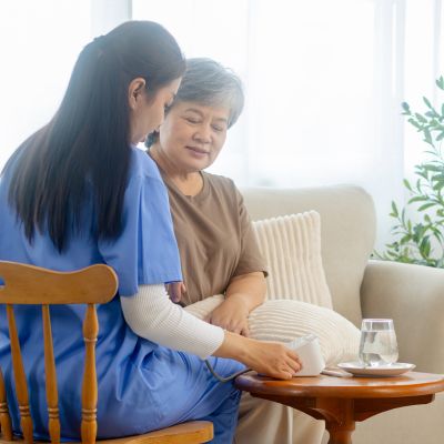 Caregiver assisting a senior woman with personal care and daily support at home in Palm Beach Gardens, Florida.