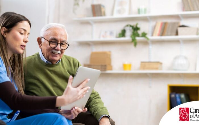 Home caregiver assisting senior man to use telehealth and senior care
