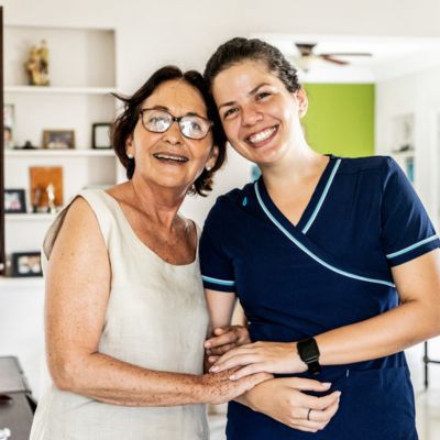 Caregiver smiling with an older adult receiving Geriatric Care Management in Margate.